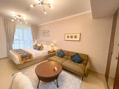 a hotel room with a bed and a couch at Cosmos Living Luxurious Studio Near Metro in Dubai