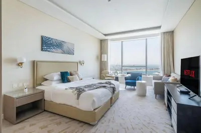 a hotel room with a bed and a living room at GuestReady - Bejeweled Studio at The Palm Tower in Dubai