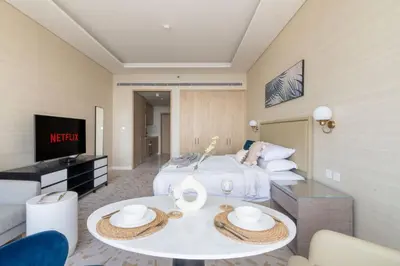 a living room with a bed and a table at GuestReady - Bejeweled Studio at The Palm Tower in Dubai