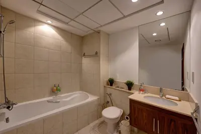 a bathroom with a tub and a toilet and a sink at Durrani Homes - Supreme 5BR besides Dubai Mall With Burj Khalifa and Fountain view in Dubai