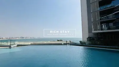 a swimming pool in front of a building at Crystal Clear 1BR in Blue Waters with Ain View in Dubai