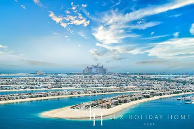 a view of a beach with a city in the background at LUX The ULTRA Luxury Palm Dubai Eye View Suite in Dubai