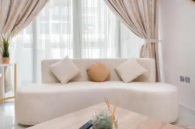 a white couch with pillows in a living room at Calm Aesthetic 3 Bedroom Villa in Dubai