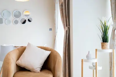 a couch with a pillow in a living room at Calm Aesthetic 3 Bedroom Villa in Dubai