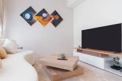 a living room with a television and a couch at Calm Aesthetic 3 Bedroom Villa in Dubai