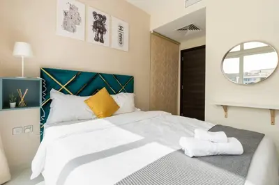a bedroom with a large white bed with a mirror at Calm Aesthetic 3 Bedroom Villa in Dubai