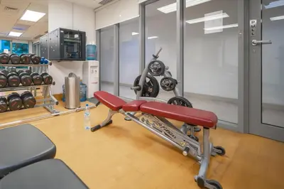 a gym with a red bench in a room at Bellavista - Dazzling High Floor - 2BR - 29 BOULEVARD - Burj Khalifa & Fountain View in Dubai