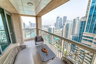 a balcony with a table and a chair on a building at Bellavista - Splendid - 2BR plus Maid - 29 Boulevard - Burj Khalifa & Fountain in Dubai