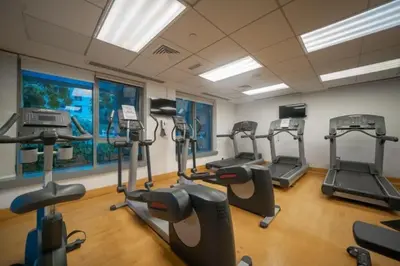 a gym with several tread machines in a room at Bellavista - Splendid - 2BR plus Maid - 29 Boulevard - Burj Khalifa & Fountain in Dubai
