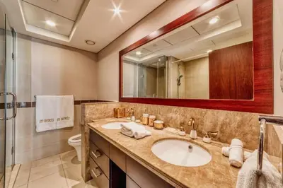 a bathroom with a sink and a toilet and a mirror at Bellavista - Splendid - 2BR plus Maid - 29 Boulevard - Burj Khalifa & Fountain in Dubai