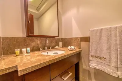 a bathroom with a sink and a mirror at Bellavista - High Floor - 1BR - 29 Boulevard - Burj Khalifa & Fountain View in Dubai