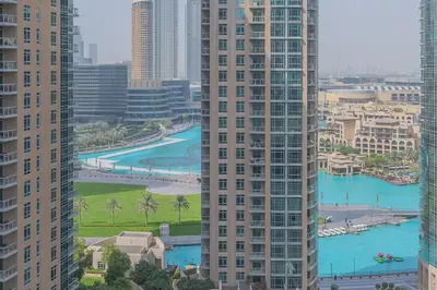 a view of a city with tall buildings and a river at Bellavista - Graceful - 2 BR - 29 Boulevard - Fountain Views in Dubai