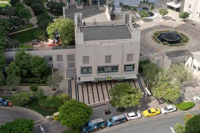 an overhead view of a building with cars parked in front at Bellavista - Graceful - 2 BR - 29 Boulevard - Fountain Views in Dubai