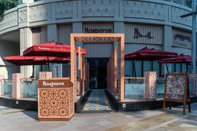 an entrance to a building with umbrellas in front at Bellavista - Graceful - 2 BR - 29 Boulevard - Fountain Views in Dubai