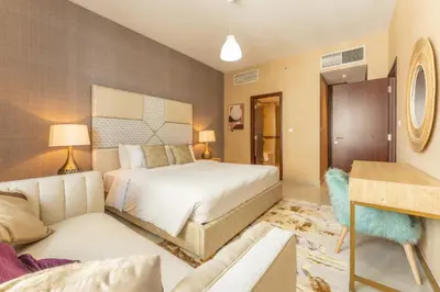 a bedroom with a large bed and a couch at Bellavista - Graceful - 2 BR - 29 Boulevard - Fountain Views in Dubai