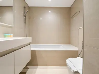 a bathroom with a bath tub and a shower at Lavishly Elegant 2BR with Breathtaking Full Burj Khalifa View in Dubai