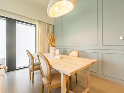 a dining room with a wooden table and chairs at Lavishly Elegant 2BR with Breathtaking Full Burj Khalifa View in Dubai