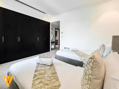 a bedroom with two beds and a mirror at Luxury 3BR Private Pool Villa and Elaborate Gardens in Dubai