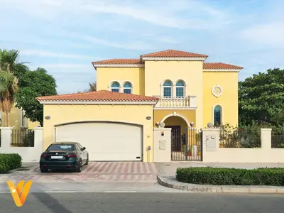 a car parked in front of a yellow house at Luxury 3BR Private Pool Villa and Elaborate Gardens in Dubai