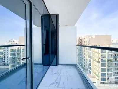 a glass balcony with a view of a city at NEW! Amazing Studio in Al Majan in Dubai