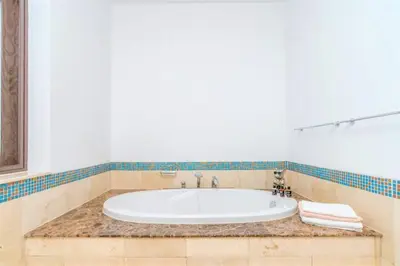 a bath tub in a bathroom with a marble counter at NEW! Exclusive Fairmont Penthouse private Pool-Gym in Dubai