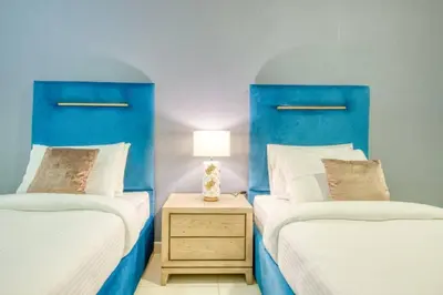 two beds with blue headboards in a bedroom at Bellavista - Magnificent - 3BR - 29 Boulevard - Partial Burj Khalifa & Fountain Views in Dubai
