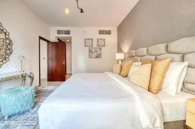 a bedroom with a large white bed in a room at Bellavista - Magnificent - 3BR - 29 Boulevard - Partial Burj Khalifa & Fountain Views in Dubai