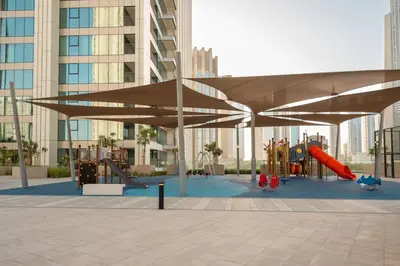 a playground with awning and play equipment in a building at Prime Retreats @ Downtown Views by Emaar in Dubai