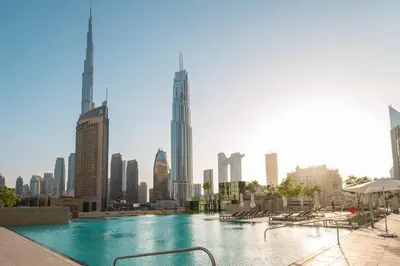 a large swimming pool in the middle of a city at Prime Retreats @ Downtown Views by Emaar in Dubai