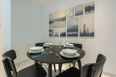 a dining room with a black table and chairs at Breathtaking 1Bed with balcony in Al Habtoor city in Dubai