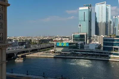 a bridge over a river in a city with buildings at Breathtaking 1Bed with balcony in Al Habtoor city in Dubai