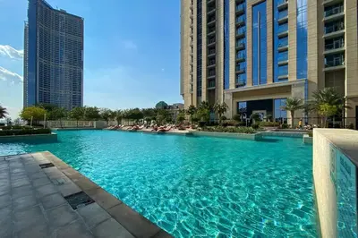 a large swimming pool in a city with tall buildings at Breathtaking 1Bed with balcony in Al Habtoor city in Dubai