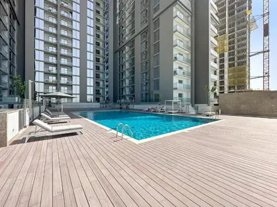 a swimming pool in a building with tall buildings at ALiving Luxury 1BR I Partial Burj khalifa Views I Sobha Creek Vista in Dubai