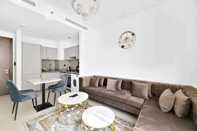 a living room with a couch and a table at ALiving Luxury 1BR I Partial Burj khalifa Views I Sobha Creek Vista in Dubai