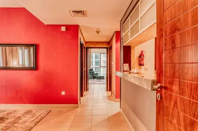 a hallway with red walls and a red door at Bellavista - Ultra Modern - 2BR - Boulevard Central - Burj Khalifa View in Dubai
