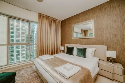 a bedroom with a large bed with a large window at Bellavista - Ultra Modern - 2BR - Boulevard Central - Burj Khalifa View in Dubai