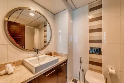 a bathroom with a sink and a mirror at Bellavista - Ultra Modern - 2BR - Boulevard Central - Burj Khalifa View in Dubai