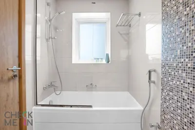 a bathroom with a tub and a shower with a window at Luxury 2BR with Breath-taking Dubai Marina Views in Dubai
