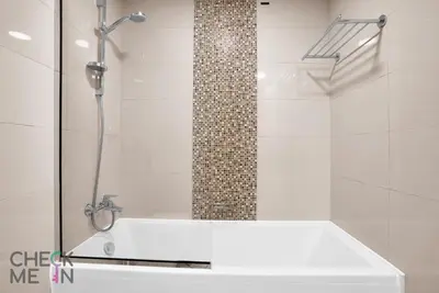 a shower with a white tub in a bathroom at Luxury 2BR with Breath-taking Dubai Marina Views in Dubai
