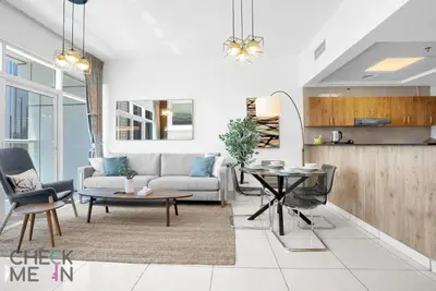 a living room with a couch and a table at Luxury 2BR with Breath-taking Dubai Marina Views in Dubai