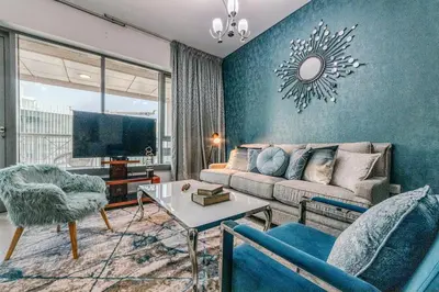 a living room with a couch and a tv at Bellavista - Spacious - 1BR with Extra Room - 29 Boulevard - Partial Fountain View in Dubai