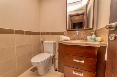 a bathroom with a toilet and a sink at Bellavista - Spacious - 1BR with Extra Room - 29 Boulevard - Partial Fountain View in Dubai