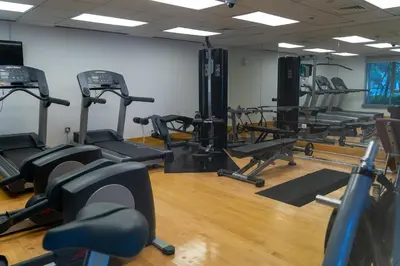 a gym with several tread machines in a room at Bellavista - Spacious - 1BR with Extra Room - 29 Boulevard - Partial Fountain View in Dubai