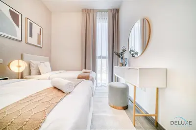 a hotel room with two beds and a mirror at Exquisite 2BR with Assistant Room at Mesk 1 Midtown Dubai Production City by Deluxe Holiday Homes in Dubai
