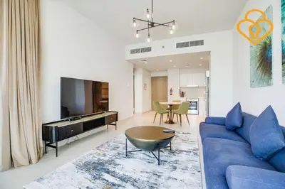 a living room with a blue couch and a table at Keysplease Spectacular Views Modern 1BR Creek Gate 602 in Dubai