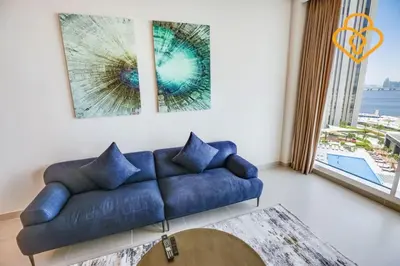 a living room with a blue couch and a large window at Keysplease Spectacular Views Modern 1BR Creek Gate 602 in Dubai