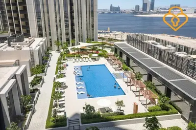 an aerial view of a building with a swimming pool at Keysplease Spectacular Views Modern 1BR Creek Gate 602 in Dubai