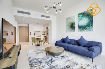 a living room with a blue couch and a table at Keysplease Spectacular Views Modern 1BR Creek Gate 602 in Dubai