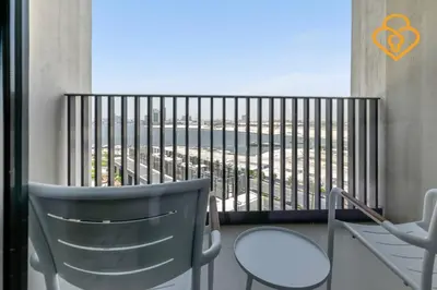 a balcony with two chairs and a view of the city at Keysplease Spectacular Views Modern 1BR Creek Gate 602 in Dubai