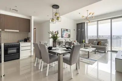 a kitchen and living room with a table and chairs at Frank Porter - 17 Icon Bay in Dubai